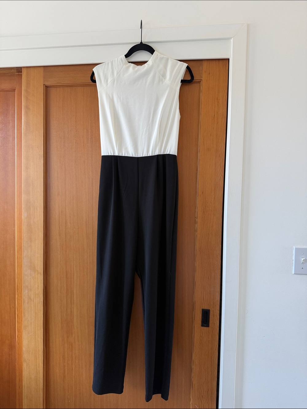 Black and white, two tone, high neck, open back jumpsuit.